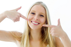 Portrait of beautiful young woman with perfect smile. Isolated on white.