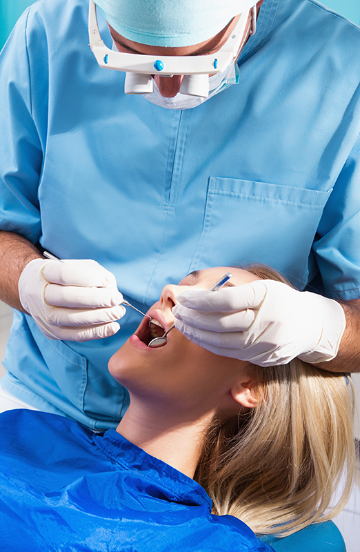 Photo of a dentist curing a girls teeth